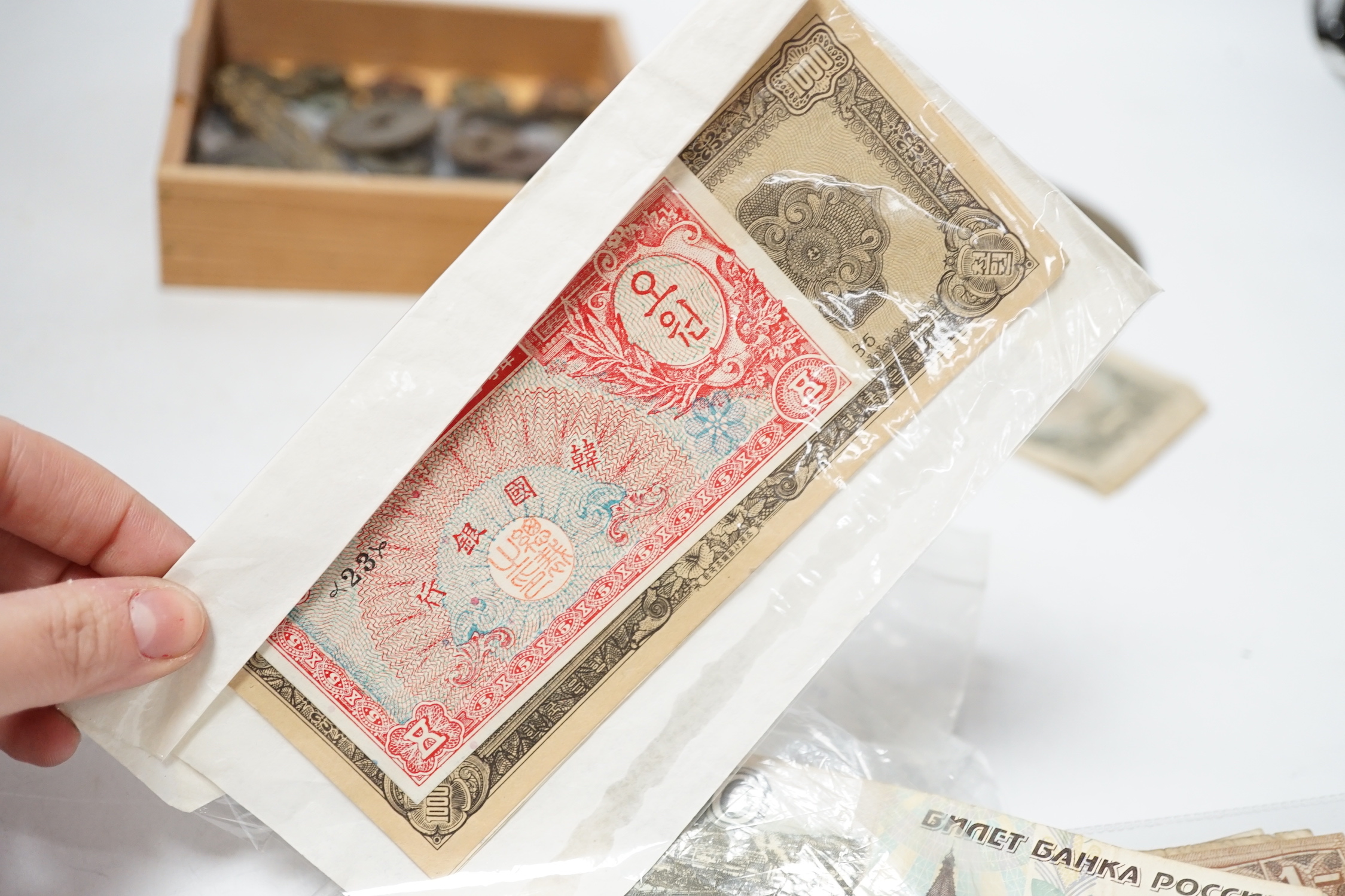 A group of Chinese tong bao cash coins, mostly Qianlong and Jiaqing and various World Bank notes including central bank of China 50 customs gold units and 20 customs gold unit
